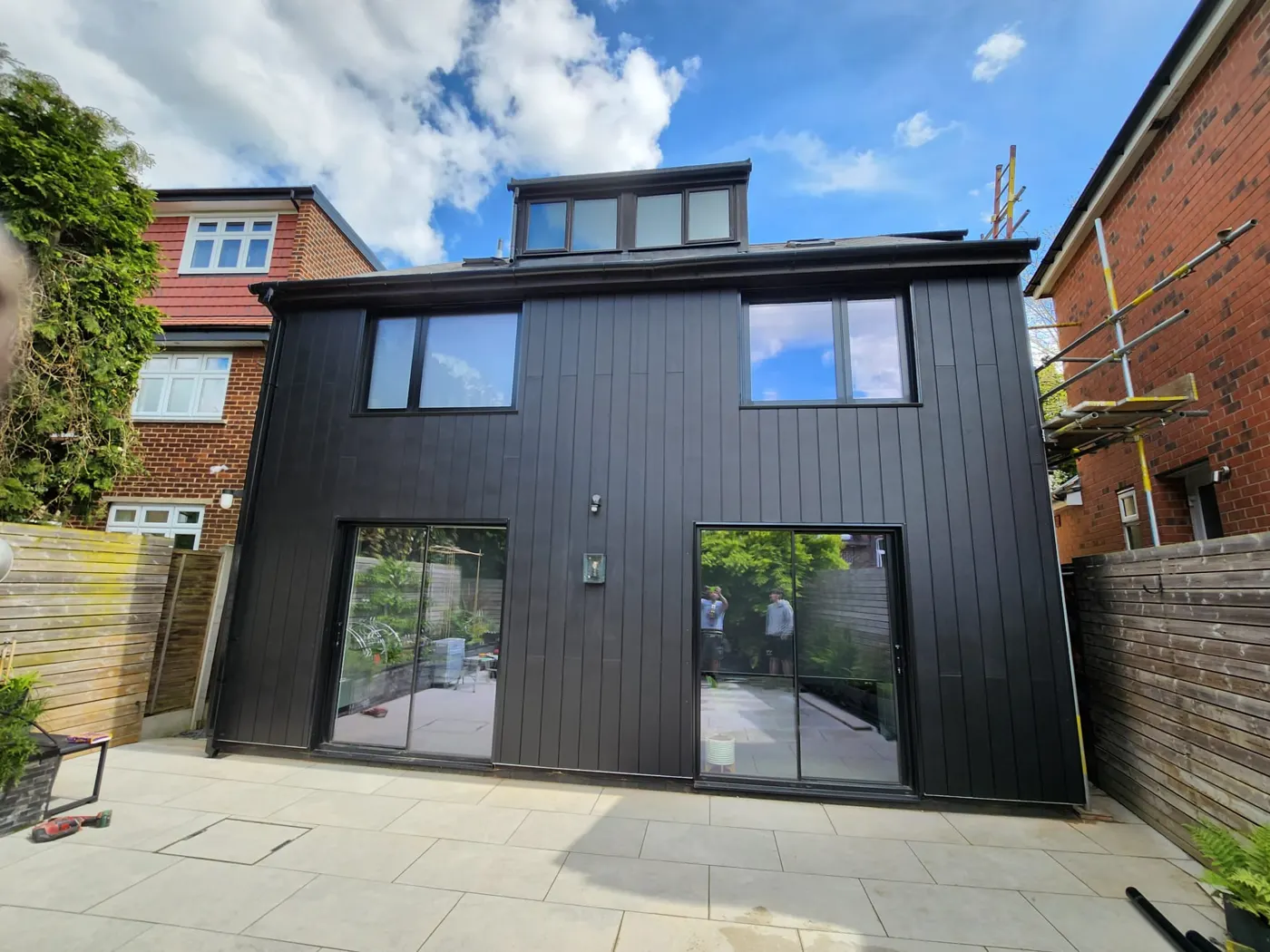The completed dark vertical cladding on the extension